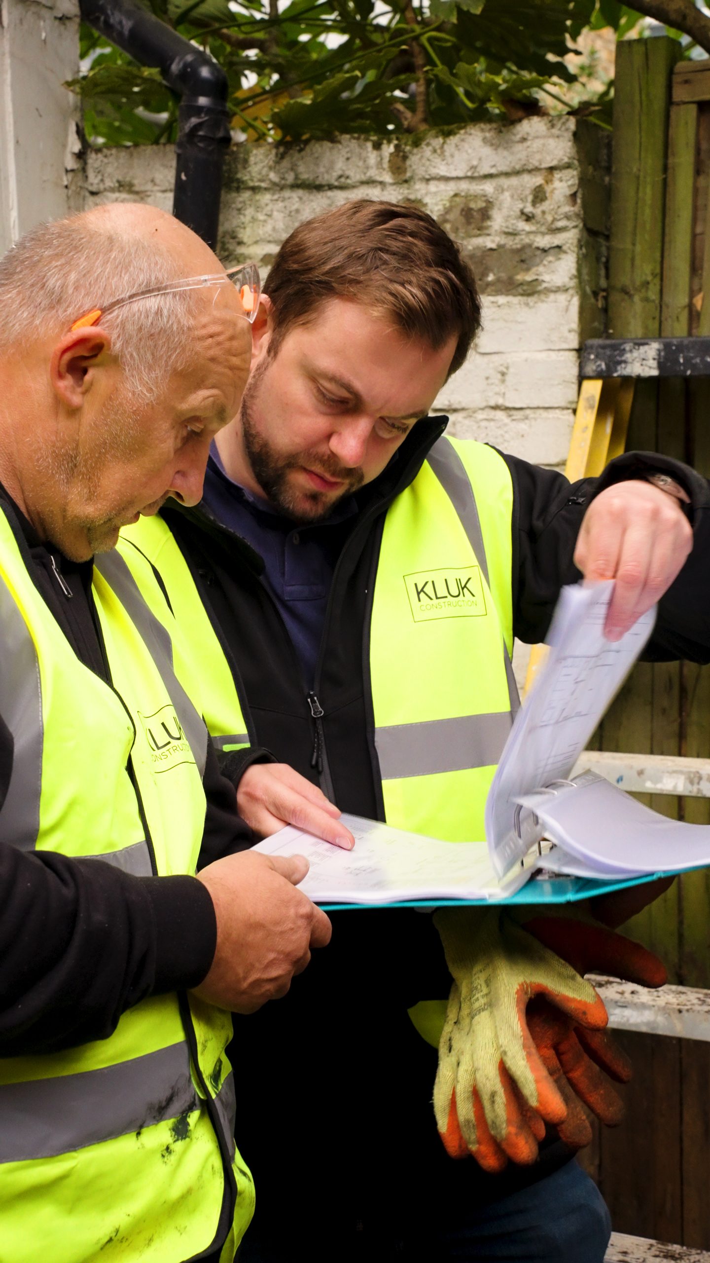 Marcin Kluk review plans with foreman on extension in Barnes